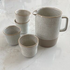 Pottery water pitcher and cups.